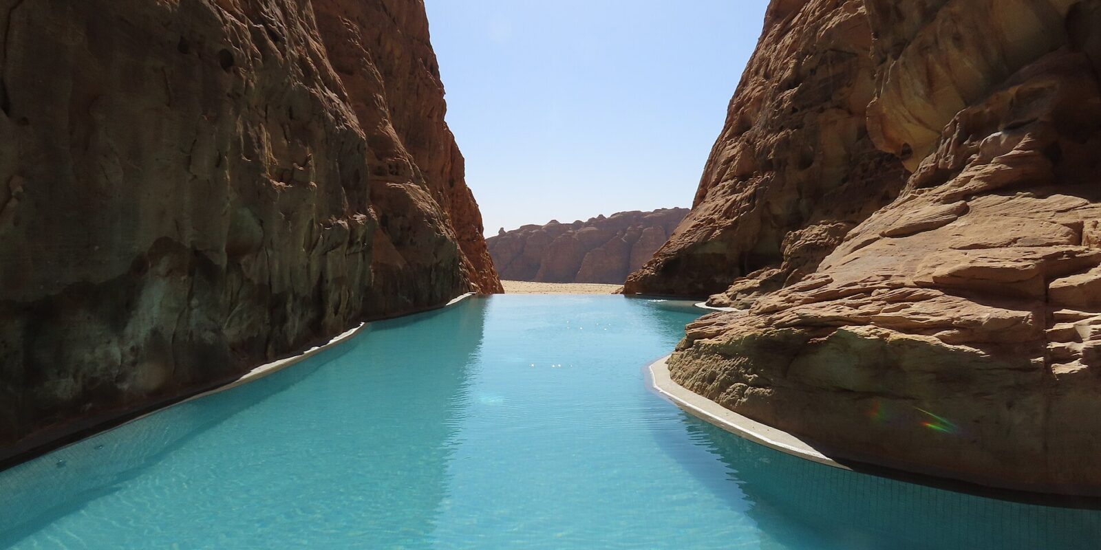 AlUla luxury resorts private-pool villa set beneath sandstone cliffs in Ashar Valley