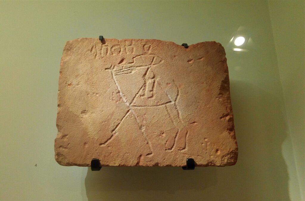 Close-up of ancient Dadanitic rock inscriptions carved into sandstone near AlUla