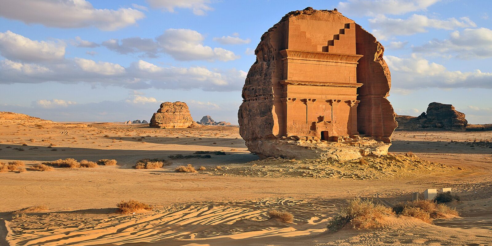 Qasr al-Farid, the largest and most famous of the Hegra tombs, standing alone on the desert plain